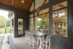 Cathedral Ceiling Covered Rear Porch With Stone Fireplace and Grilling Station