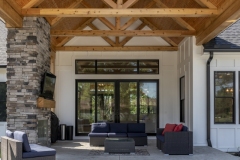 Covered Exterior Porch With Stone Fireplace and Cathedral Ceiling