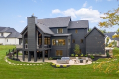 Cathedral Ceiling Covered Rear Porch With Stone Fireplace and Grilling Station