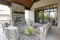 Covered Exterior Porch With Stone Fireplace and Cathedral Ceiling