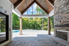 Covered Cathedral Ceiling Rear Porch With Fireplace and Pool
