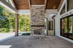 Covered Cathedral Ceiling Rear Porch With Fireplace and Large Slider Door