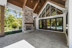 Covered Exterior Porch With Stone Fireplace Large Slider Door To Great Room