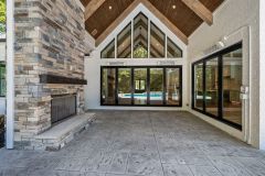 Covered Exterior Porch Cathedral Ceiling With Stone Fireplace Large Slider Door To Great Room