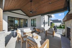 Covered Exterior Porch With Stone Fireplace and Cathedral Ceiling