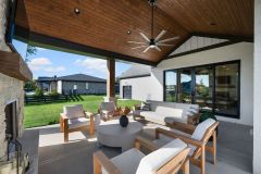 Covered Exterior Porch With Stone Fireplace and Cathedral Ceiling