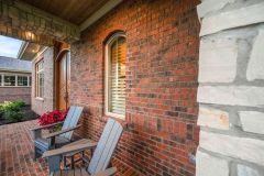 Brick covered front porch with stone accents
