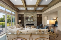 Great Room With Coffered Ceiling Large Windows stone linear fireplace