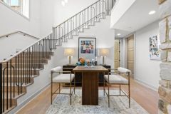 Open Staircase With Wood Accent Ceiling To Lower Level