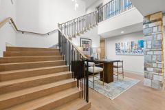 Open Staircase With Wood Accent Ceiling To Lower Level