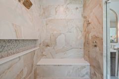 Oversized linear shower niche with accent tile and bench