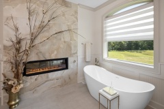 Primary Suite Two sided Fireplace With Free Standing Tub