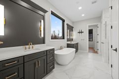 Primary-Bathroom-with-His-and-Her-Black-Cabinetry-with-Gold-Accents-and-Free-Standing-Tub-2