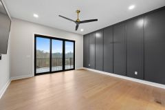 Primary-Bedroom-with-Black-Accent-Wall-and-Walk-out-1