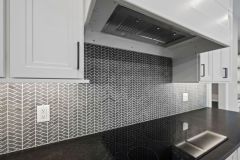 Gray herringbone mosaic backsplash