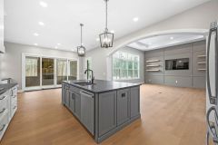 dark gray island with a leathered granite countertop