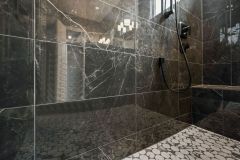 dark porcelain tile shower walls, a mosaic shower floor