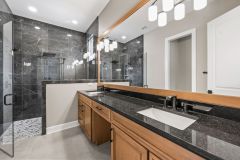 custom cabinetry and mirror in the primary bathroom