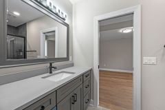 Lower level Bathroom With Custom Cabinetry and Framed Mirror
