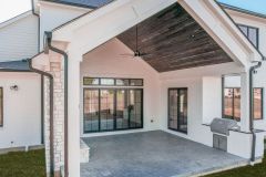 Covered Patio with Custom Fireplace and Grill Station at The House of Peace