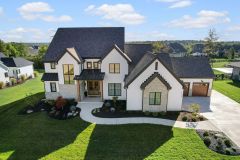 White painted Brick Modern Farmhouse with Metal Roof Accents