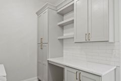 LaundryWith Custom Cabinetry and Open Shelving