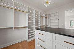 Custom-Walk-In-Closet-With-Island-and-Window-4