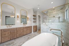 double-sink-vanity-with-built-in-white-oak-cabinetry-and-brushed-gold-fixtures-1