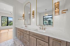 White Oak Double Sink Vanity With Gold Plumbing Accents