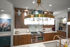 Double Chandelier Statement Lighting Over Island Modern Crystals and Antique Brass Finishes
