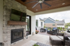 Covered Porch with Fireplace and Sun Deck at The Bradford