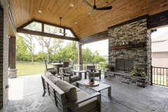 Covered Porch with Fireplace and Seating Area at Stony Oaks