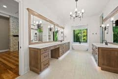 Primary Bathroom with His and Her Vanity Free Standing Tub and Mirror With Integrated Sconces - The Vandoren