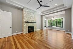 Primary Bedroom with Floor To Ceiling Stone Fireplace - The Vandoren