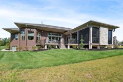 Rear Covered Porch With Stone Fireplace and Sun Deck