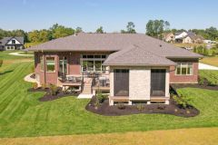Rear Covered Porch With Stone Fireplace and Sun Deck