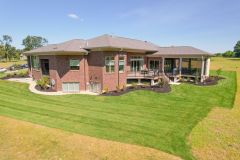 Rear Covered Porch With Stone Fireplace and Sun Deck