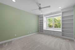 Girls bedroom with built-in bookcase and window seat - The Vandoren