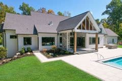 custom home in Liberty Twp with rear covered porch with stone fireplace and pool-The Vandoren