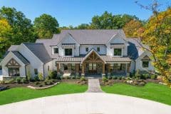 Custom home in Liberty Twp with covered front porch, Gables, Cedar Columns, metal accents and white brick - The Vandoren
