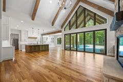 Great Room With Cathedral Ceilings and Beams Open To Kitchen and Dining - The Vandoren