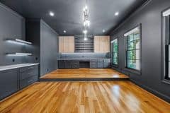 His Office With Dark Color Drenching Two Tone Cabinetry