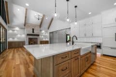 Kitchen with stained island cabinets and perimeter white cabinets - The Vandoren