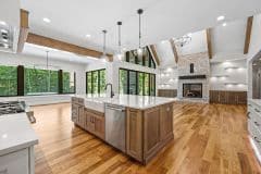 Custom home with open view from kitchen to cathedral ceiling great room with beams - The Vandoren