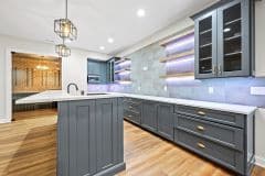Integrated lighting with open and closed storage lower level pub style bar