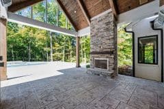 Outdoor Cvovered  Porch wit hStone Fireplace and Pool - The Vandoren