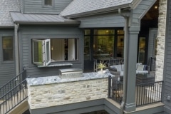 Custom home covered porch pass through window and grilling station