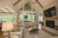 Custom home great room with cathedral ceiling white oak beams