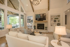Great Room with cathedral ceiling beams and stone fireplace