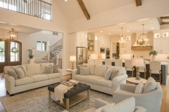 Custom home Great Room with cathedral ceiling beams open to kitchen
